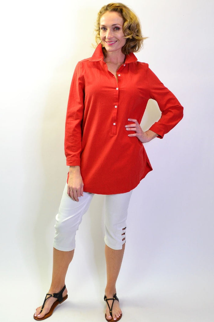 Burnt orange Hourglass button-up tunic shirt with elegant collar and long sleeves, displayed on a hanger.