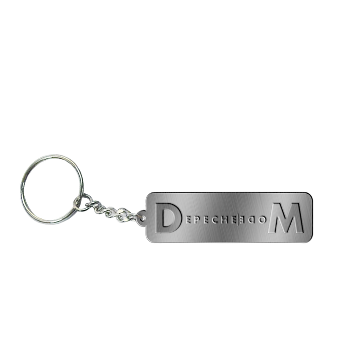 A metal keychain with the embossed text 'DEPECHE MODE'.