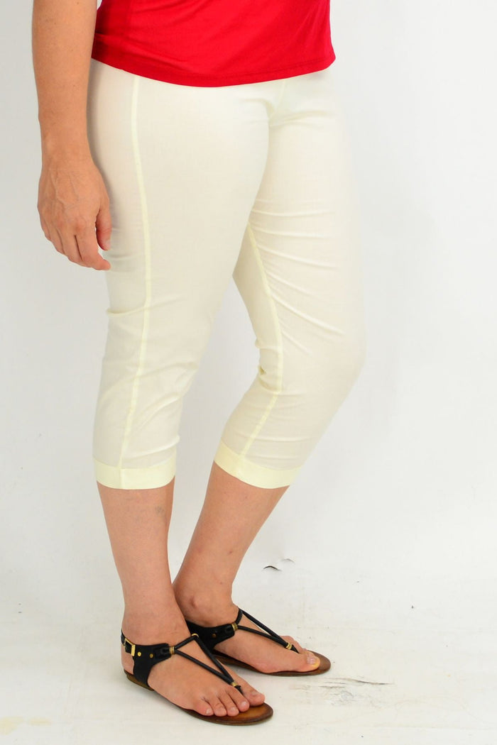 Light ecru cream cotton pants from One Summer, displayed on a hanger with a relaxed fit and subtle texture.