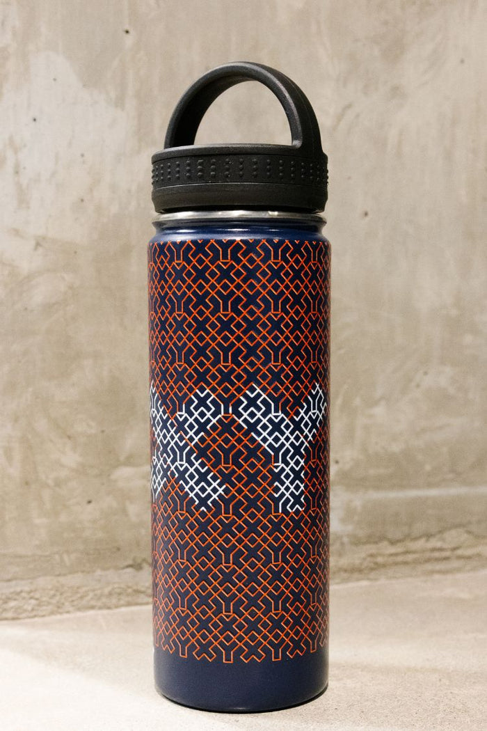Blue water bottle with black lid and geometric pattern on a textured surface || Navy Patriotic