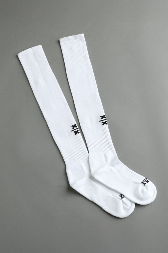 Two white knee-high socks with black logo on a gray background || White
