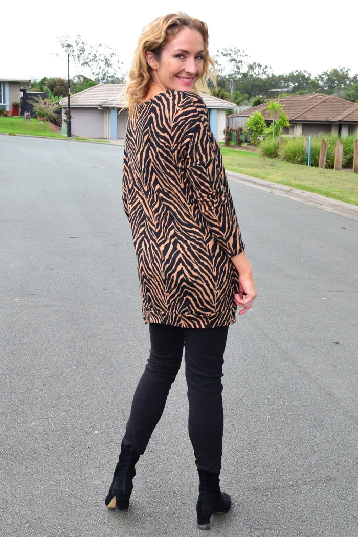 Caroline Morgan zebra stripe hi-low tunic top featuring black and white patterns, flowing fit, and casual style.