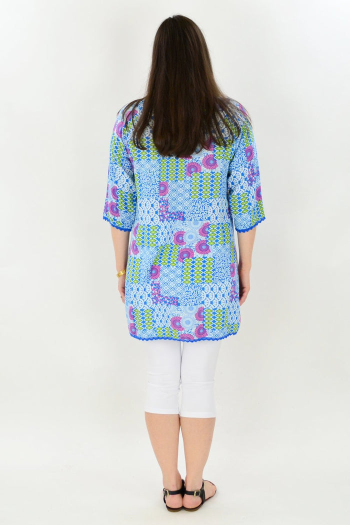 One Summer Zen Garden Tunic Blouse with floral print, lightweight fabric, and relaxed fit, displayed on a hanger.